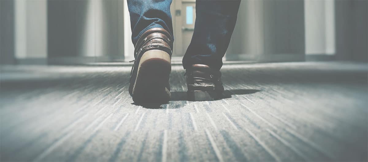 Feet walking on commercial glue down carpet after office carpet cleaning in Denver