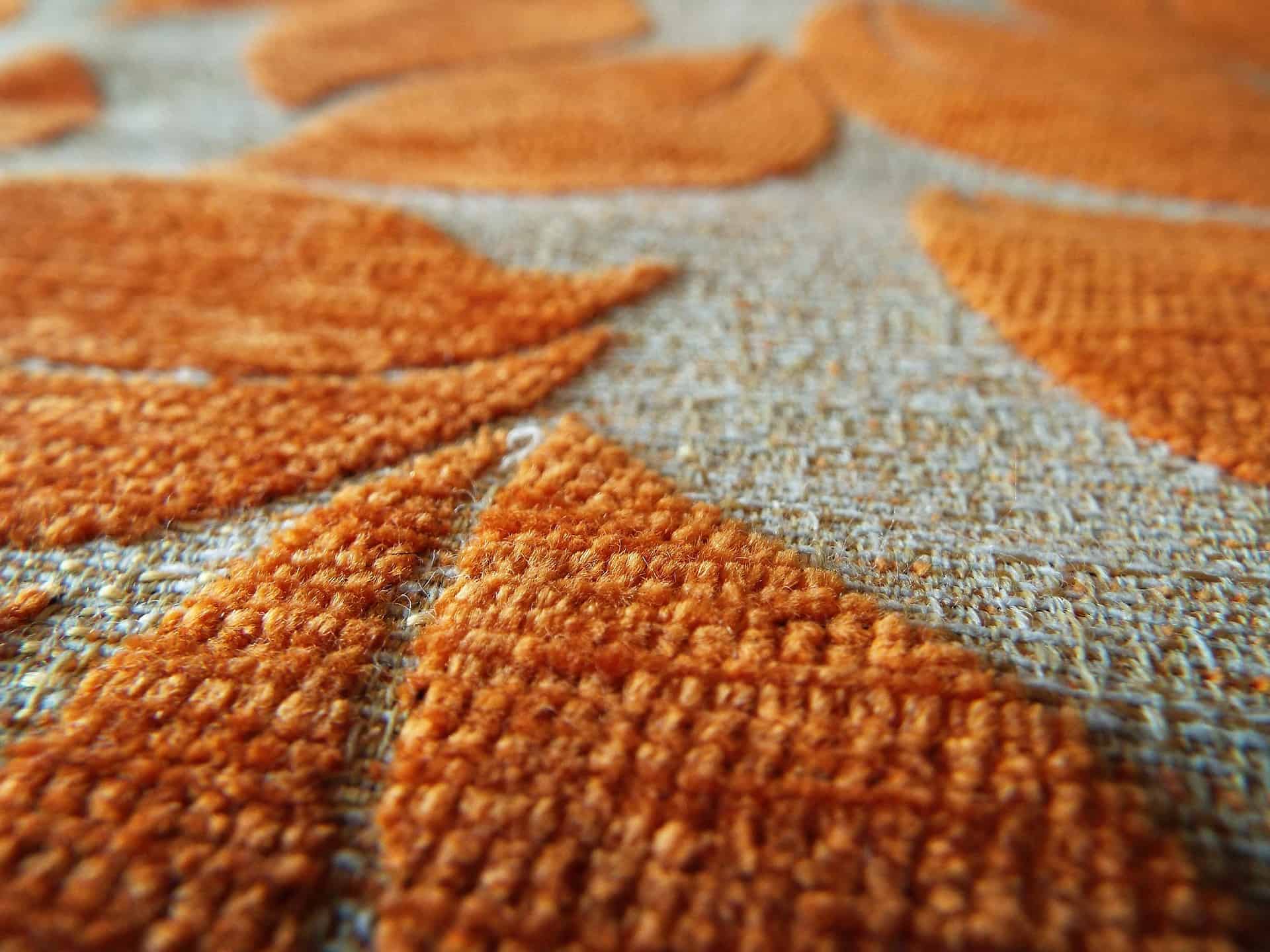 orange and white patterned nylon carpet