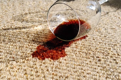 A carpet protector or upholstery protector like Scotchgard can help avoid stains on carpet or upholstery like the wine spill in this image