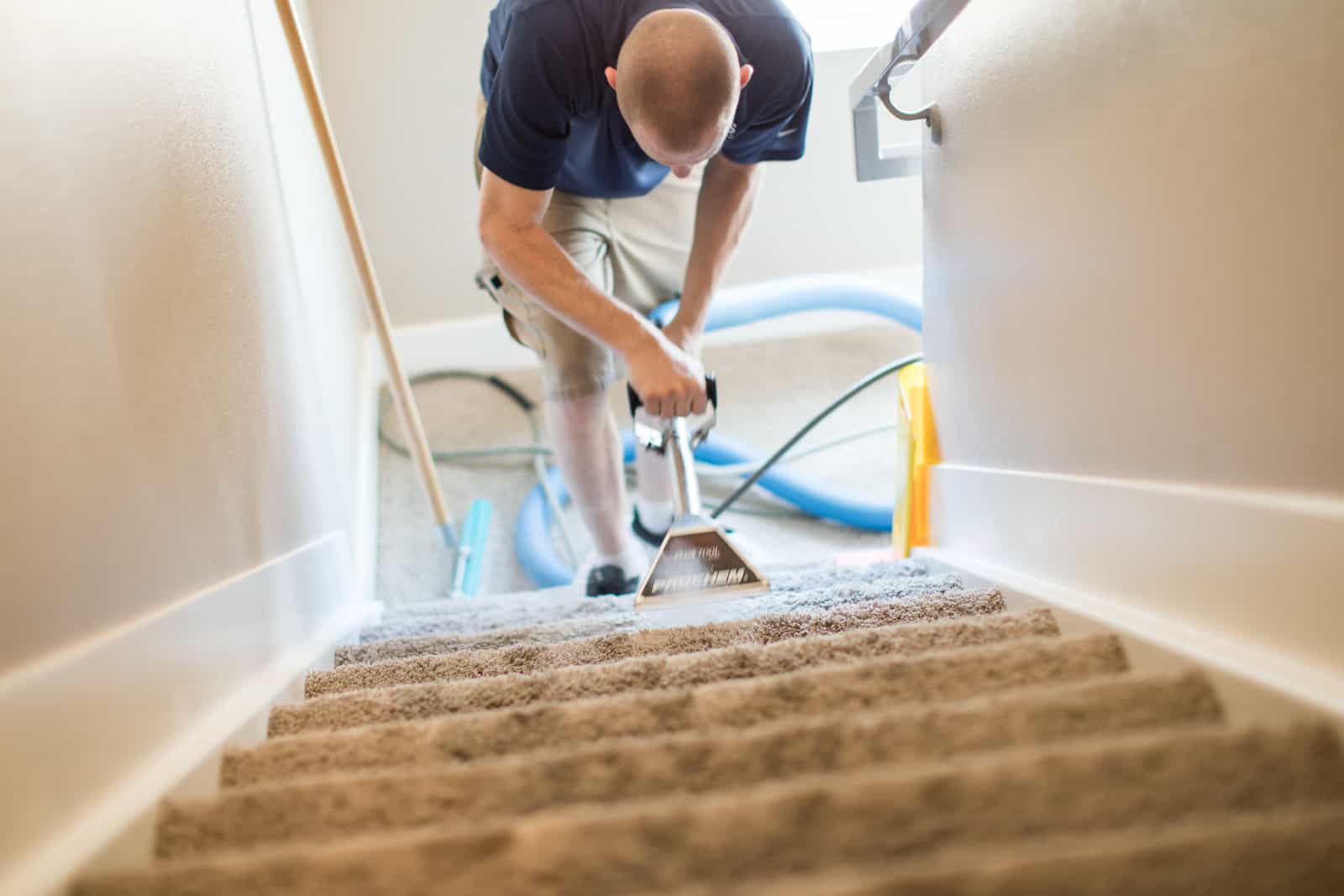 MSS Cleaning employee carpet cleaning staircase with a stair tool