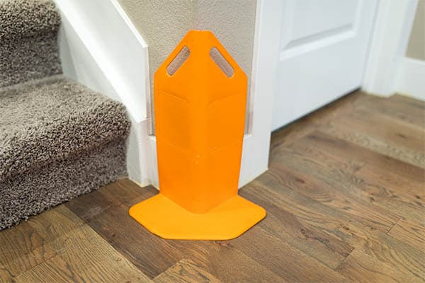 Orange corner guard used to protect walls and molding during Littleton carpet cleaning services