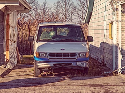 old beat up carpet cleaning equipment and van