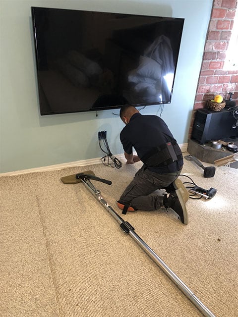 Tucking stretched carpet against a wall