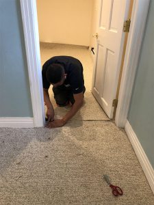 Alberto installing carpet in doorway