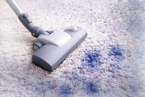 Blue ink stain on white carpet