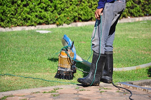 Using a sump pump to extract water from flooded area